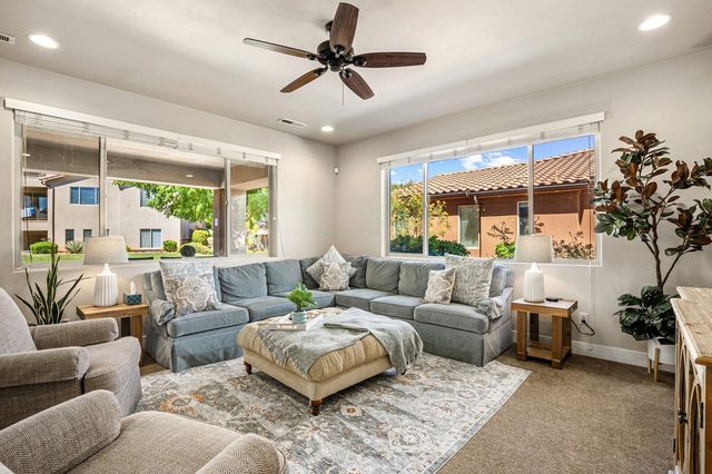 Home 31 living room with gray sectional and tufted ottoman