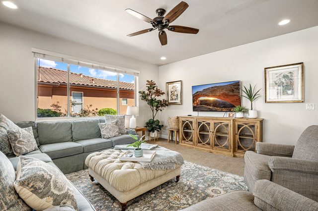 Home 31 living room with sectional sofa and wall-mounted TV
