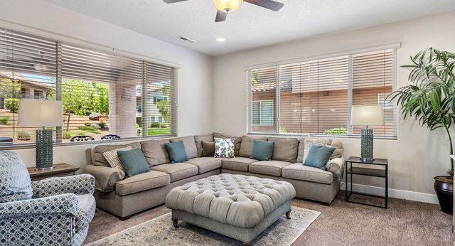 Home 32 living room with large sectional and tufted ottoman