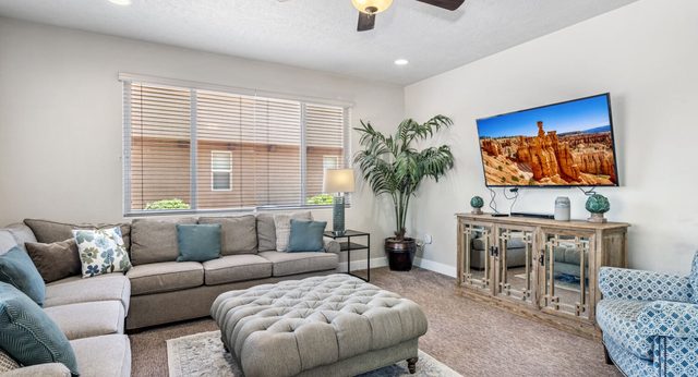 Home 32 living room with sectional sofa and mounted TV