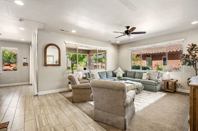Main living room with sectional sofa and armchairs