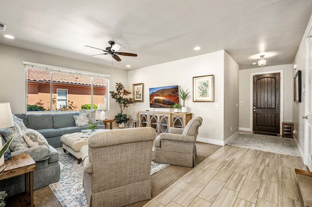Living room seating facing the TV and front entry
