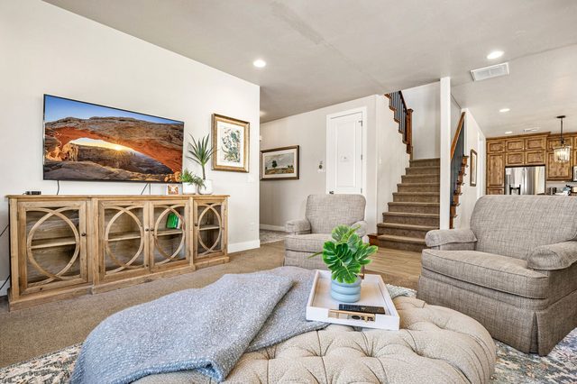 Living room armchairs and TV near the stairs at Paradise Village 31