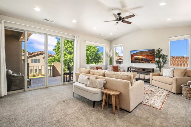 Upstairs living room with sofas and balcony sliding doors