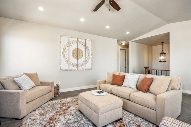 Second living room with sofa and ottoman upstairs