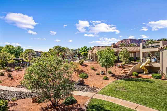 View over the community grounds toward red cliffs from the balcony