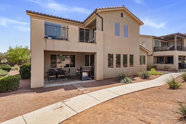 Back of Paradise Village 32 with covered patio and grill