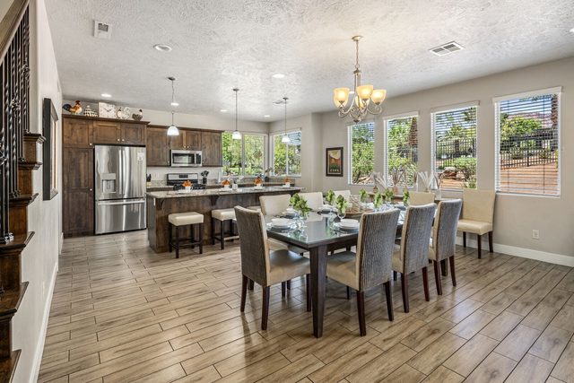 Dining table for eight beside the open kitchen at Paradise Village 32
