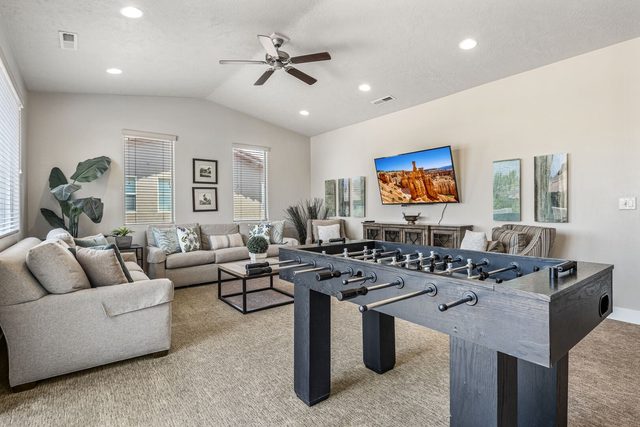 Upstairs loft lounge with sectional sofa, TV and foosball table at Paradise Village 32
