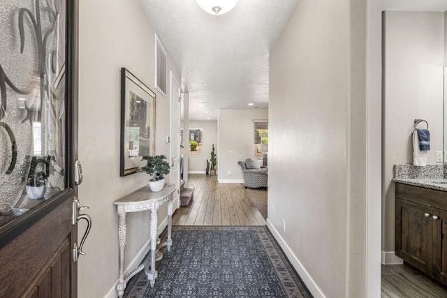 Front entry hallway with console table and runner rug at Paradise Village 32