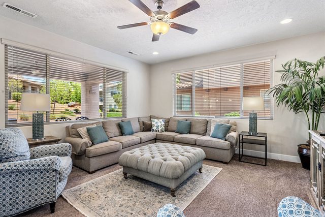 Main living room with large sectional and tufted ottoman at Paradise Village 32