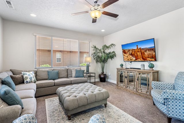 Living room sectional, armchairs and wall-mounted smart TV