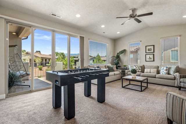 Upstairs loft with foosball table and sliding doors to balcony