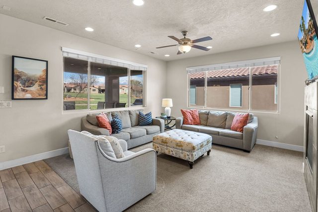 Main living room with two sofas and upholstered ottoman at Paradise Village 36