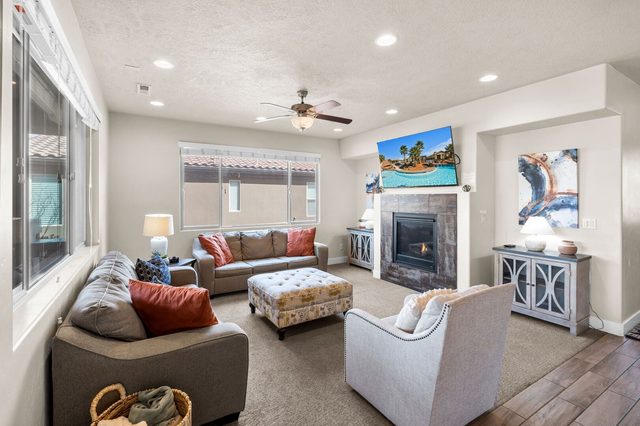 Living room with gas fireplace, sofas and wall-mounted TV