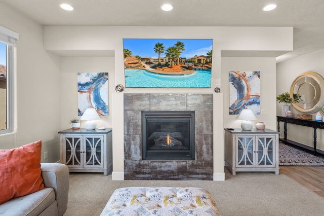Gas fireplace with tile surround and TV above in living room