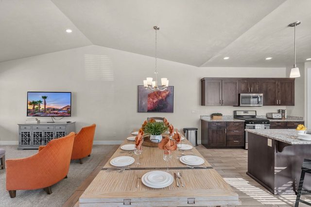 Dining table set for eight next to the open kitchen
