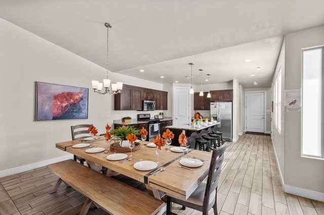 Farmhouse dining table with bench leading to the kitchen