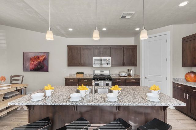 Granite kitchen island with bar seating and gas range