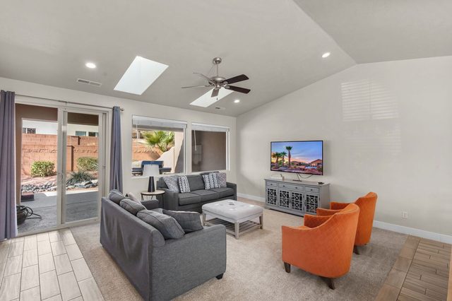 Living room with skylight and sliding doors to the patio