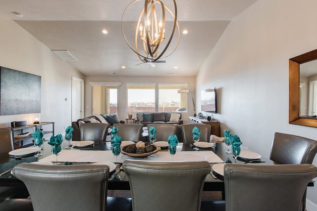 Long dining table with chandelier at Paradise Village 78