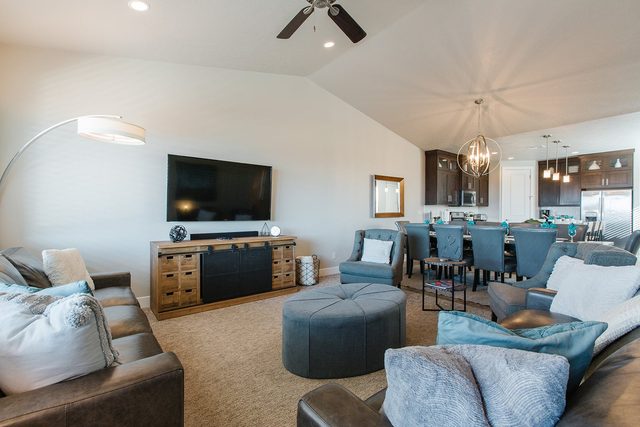 Living room leather sofas and TV beside the dining area