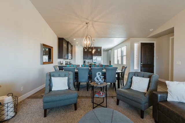 Accent chairs in the living room facing the long dining table