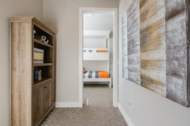 Upstairs hallway with bookshelf leading to the bunk room