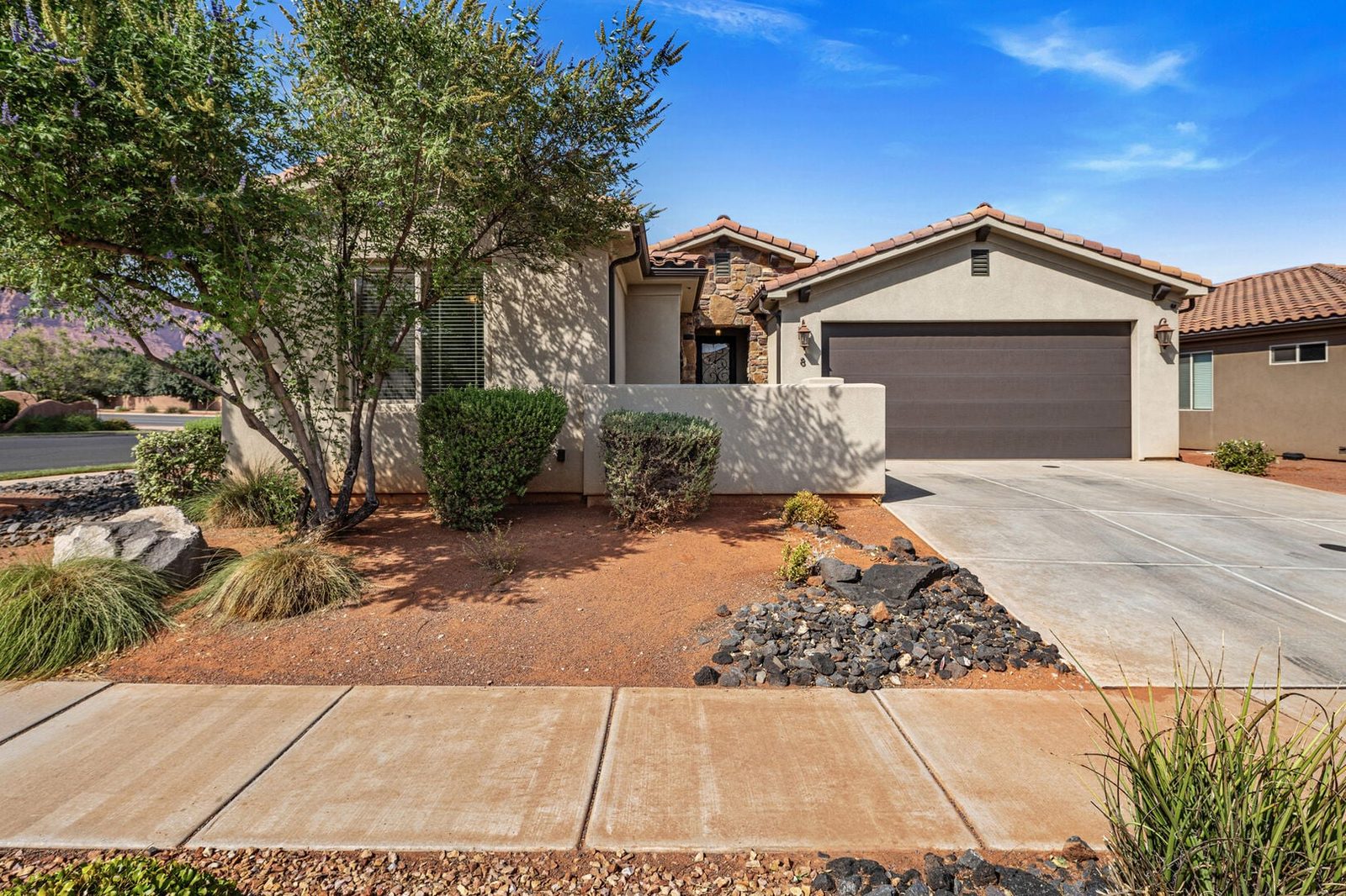 Front of Paradise Village 8 single-level home with two-car garage