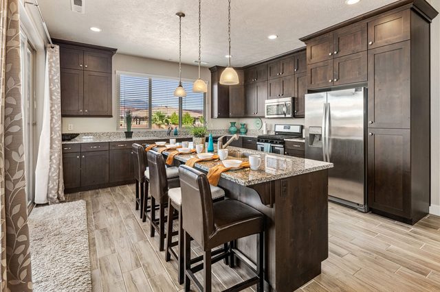 Kitchen island with bar stools and dark wood cabinets