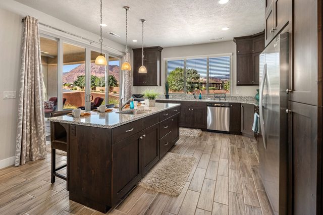 Kitchen island with sink and stainless appliances