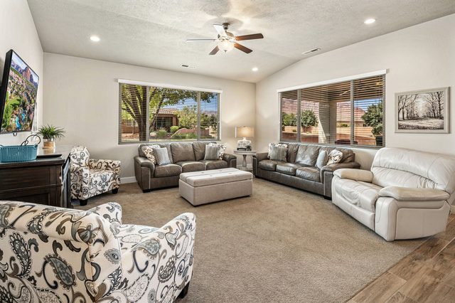 Living room seating around a large tufted ottoman
