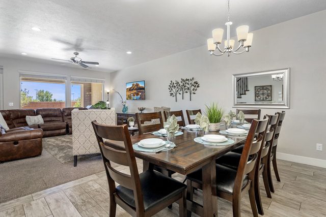 Dining table for eight beside the leather sectional living area