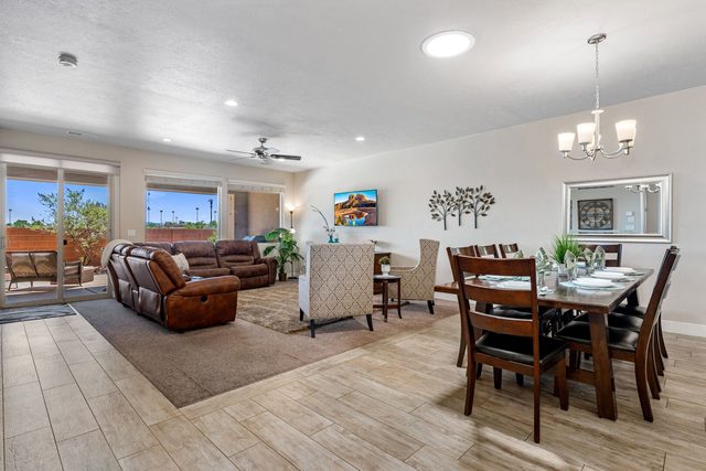Open great room with leather sectional and dining table at Paradise Village 80