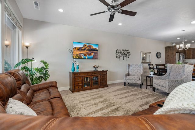 Leather sectional facing the TV with dining room beyond