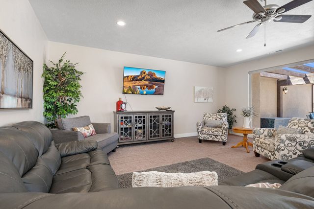 Upstairs family room with leather sectional and wall TV