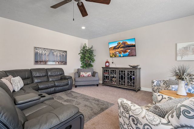 Second living room with recliners, armchairs and TV console