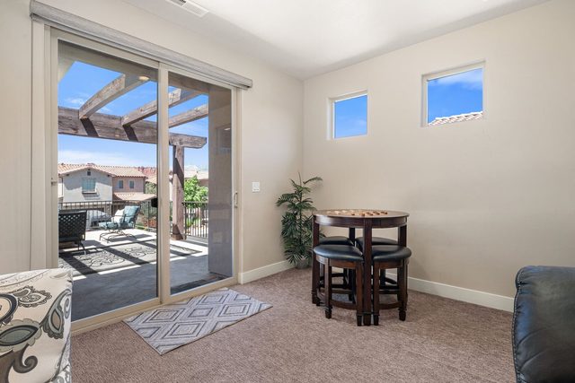 Game table for four beside sliding doors to the balcony