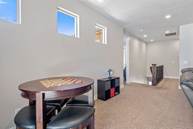 Round game table in the upstairs family room near the stairs