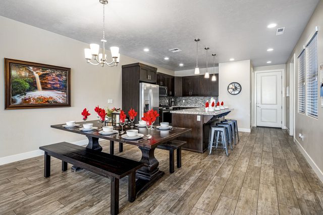 Dining table with bench seating beside the open kitchen