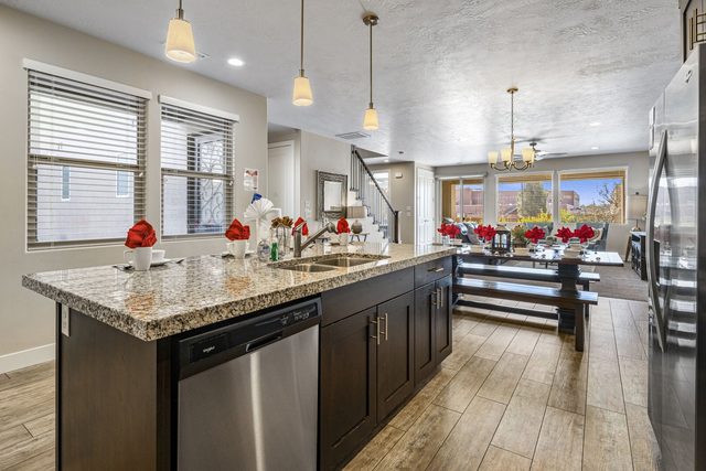 Granite kitchen island with dishwasher overlooking the dining area