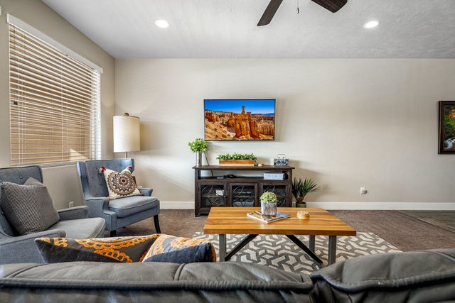 Living room seating area around wood coffee table and TV