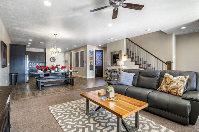 Living room sofa facing the dining area and entry staircase