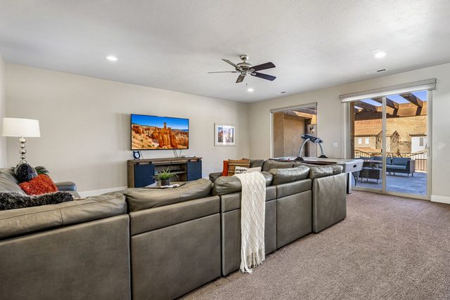 Upstairs loft with oversized sectional, TV and balcony access