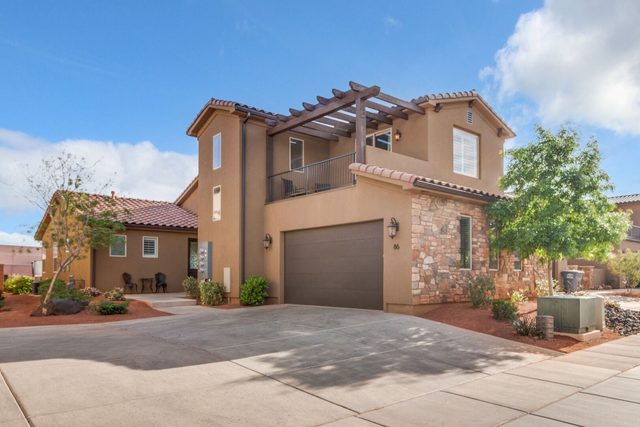 Front of Paradise Village 86 townhome with garage and pergola balcony