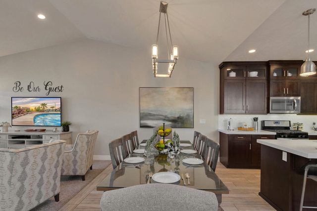 Glass dining table beside open kitchen and living area