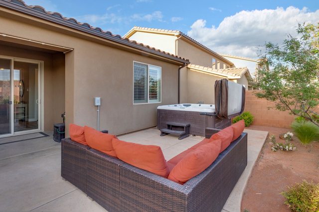 Backyard sectional sofa beside private hot tub at Paradise Village 86