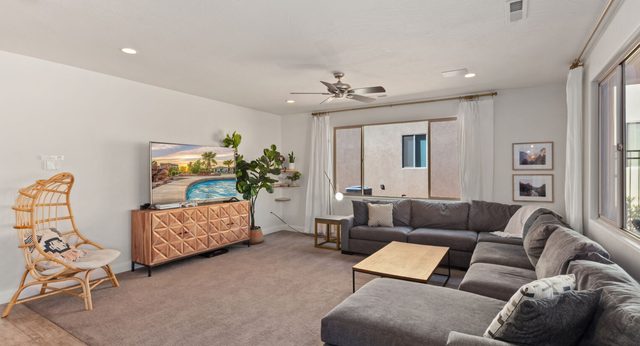 Home 94 living room with sectional sofa and wall-mounted TV