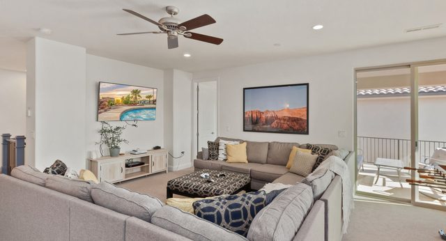 Home 94 upstairs loft with large sectional sofa and TV
