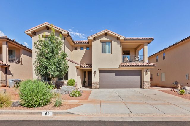 Front of Paradise Village 94 with two-car garage and upper balcony